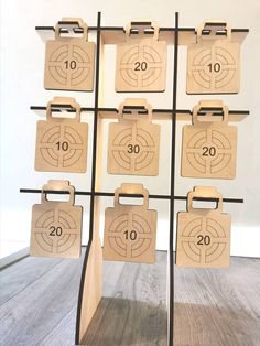 a wooden calendar is hanging on a metal rack with numbers and clipboards attached to it