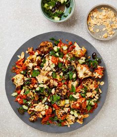 a plate full of food next to two bowls filled with nuts and other foods on the table