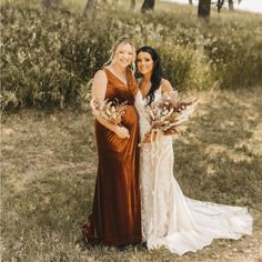 two women standing next to each other in a field