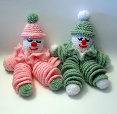 two crocheted clowns sitting next to each other