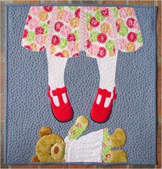 there is a quilted picture of a child's feet with flowers on them