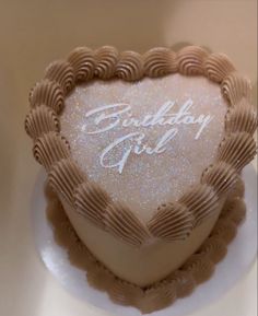 a heart shaped cake with the words birthday girl written in white frosting on it