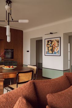 a living room and dining area with wood paneling