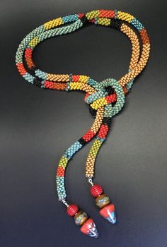 a multicolored rope with two beads on it and a hook in the middle