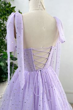 Indulge in luxury with our Corset Lavender Star Tulle Dress. The intricate corset design cinches your waist, while the removable tie straps add versatility. The dreamy tulle material and delicate star embroidery make this dress a work of art. Elevate your style with this exclusive piece. Bust and Skirt with full lining. 100% Polyester 100% Recycled polyester lining Concealed zip at center back Imported Corset Design, Tulle Material, Pastel Dress, Floral Pattern Dress, Graduation Dresses, Star Embroidery, Fabric Accessories, British Indian, Mozambique