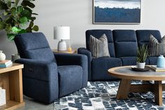 a living room with two blue recliners and a coffee table