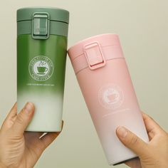 two people holding up different colored cups in their hands, one is green and the other is pink