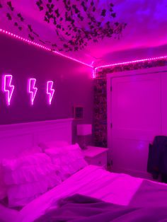 a bed room with a neatly made bed and purple lights on the wall above it