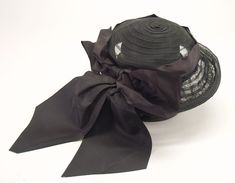 Vintage Lady's Black Woven Veiled Hat with 3" Brim, Satin 9" Long  Ribbon, and 10" Satin Bow.  Ribbon is 4 1/2" wide and encircles the crown folded in half.  Rolled edge on brim.  Nylon Hat.  Excellent Condition. Vintage Black Costume Hats And Headpieces For Church, Vintage Black Top Hat For Church, Vintage High Crown Black Costume Hat, Retro Black Hat For Vintage Events, Vintage Black Top Hat For Costume, Vintage Black High Crown Costume Hat, Vintage Black Kentucky Derby Costume Hat, Vintage Black Hat For Church, Cheap Vintage Black Hat