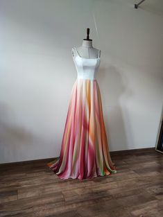 a dress on a mannequin in front of a white wall and wooden floor