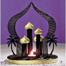 a decorative candle holder with three candles in it and palm trees on the base, against a purple background