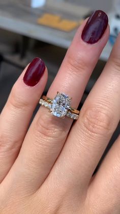 a close up of a person's hand with a ring on their finger and a diamond in the middle