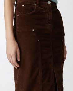 Straight-cut, five-pocket skirt in soft, stretch modal- and cotton-blend corduroy with fine ribbing. Midi-length garment with belt loops at the waist, slit in the middle at the bottom and workwear-inspired topstitching and rivets on the front. Metal zip and tack-button fastening. Long Corduroy Skirt, Corduroy Midi Skirt, Pocket Skirt, Calf Length Skirts, Corduroy Skirt, Chestnut Brown, Mid Dresses, Mid Length Dresses, Dress Trousers