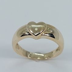 This beautiful heart signet ring has been carefully crafted in 10k Yellow Gold. This delicate ring will make a beautiful any occasion gift. All of my jewelry is handmade from scratch and of high quality. This ring can be personalized with your initials upon request. Ring is size 5 1/2 but I can resize it at no extra cost and will ship it to you in an elegant gift box.    Ring Weight: 3.9 grams Ring Size: 6 1/2 Face of the Ring is 6.9 mm x 7.15 mm  Band at smallest point: 2.5 mm Materials: 10k Ye Heirloom 14k Gold Heart Promise Ring, Classic Heart-shaped Stackable Promise Rings, 14k Gold Heart Ring With Polished Finish For Wedding, Classic Double Heart Promise Jewelry, Classic Heart Ring With Polished Finish For Promise, Heart Cut Signet Ring For Anniversary On Valentine's Day, 14k Gold Heart Ring For Valentine's Day, Classic Heart Cut Stackable Rings For Anniversary, Classic Round Band Jewelry For Valentine's Day