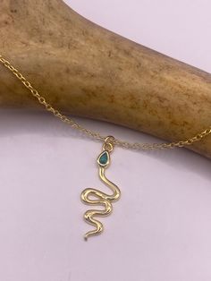 Vintage tiny mini snake hangs from a delicate chain  Gold finished 925 sterling silver, does not tarnish  This tiny treasure is about 3/4 inch wide Hangs on a gold finished 925 sterling silver chain 16-18 inches adjusts.  We have options for longer chains  Lovely etched design Chrome diopside set in the head  Thank you for supporting a small veteran owned business! All jewelry is shipped free within the US in a stylish gift box Tiny Snake, Snake Lovers, Green Chrome, Photo Locket Necklace, Snake Pendant, Snake Jewelry, Gold Charm Necklace, Sterling Silver Chain Necklace, Silver Lockets