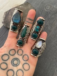 A unique unisex Boho style chunky ring, made out of white metal and Jade stones, Labradorite, Turquoise and moonstone. The band has embossed details and the ring is size adjustable for you to choose in which finger you want to wear it. Being size adjustable makes this ring the perfect gift for your love one. A must have addition to your jewelry collection. Choose your favorite from 6 different styles. Style 1- 2 inch- 5cm long Style 2- 1.90 inch- 4.7cm long Style 3- 1.60 inch- 4cm long Style 4- Chunky Stone Rings, Bohemian Turquoise Ring With Natural Stones, Bohemian Green Crystal Ring, Bohemian Adjustable Open Crystal Ring, Adjustable Bohemian Open Ring Crystal, Bohemian Green Metal Rings, Bohemian Silver Rings With Stones, Bohemian Crystal Ring With Stones, Bohemian Open Ring Crystal Ring For Healing