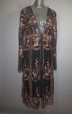 Semi Sheer Cover Up, Black Sheer with Gold Metallic Embroidery,  Long cardigan, HAUTE MONDE Label, Empire Waist, Front tie, Long Sleeves, Very good condition. Tag says  Medium. Measurements: 15" across top of shoulders 36" bust 32" empire waist 43.5" long Black Embroidered Long Sleeve Cardigan, Bohemian Long Sleeve Cardigan For Party, Fitted Bohemian Cardigan With Floral Embroidery, Fitted Long Cardigan For Party, Fitted Bohemian Embroidered Cardigan, Bohemian Fitted Cardigan For Party, Elegant Black Embroidered Cardigan, Embroidered Long Sleeve Cardigan For Festival, Embroidery Cardigan