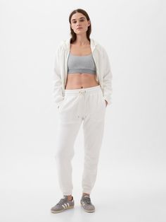 Soft knit joggers.  Elasticized waist with drawcords.  Front slant pockets.  Banded, elasticized cuffs.  These joggers are made with 23% recycled polyester.  Less waste in the world.  More great clothes for you.  Mid rise.  Easy through the hip and thigh.  Skinny leg opening.  Skims the ankle. Knit Joggers, Soft Classic, Vintage Soft, Petite Size, Soft Knits, Black And Navy, Heather Grey, Mid Rise, Gap