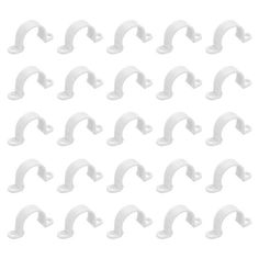 white plastic brackets are arranged in a pattern on a white background stock photo - 1387982