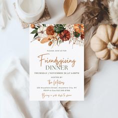 a thanksgiving dinner party with flowers and leaves