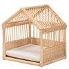 a small wooden crib with a white pillow on the bottom and side panels, in front of a white background