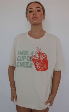 Have a cup of cheer! We love the vintage, festive feel that this shirt gives. It’s classic and timeless but still fun, which is what Christmas fashion is all about. Throw this shirt on to host your holiday parties and let people know you’re a good time from the moment they walk in your house. Lili is 5'7" and is wearing size medium Mary Claire is 5'8" and is wearing size medium sizing guide: small: 36” bust | 28” length medium: 39" bust and 28.5" length large: 42” bust | 30” length extra large: Have A Cup Of Cheer, Cup Of Cheer, Cheer Tshirts, What Is Christmas, Re A, Christmas Fashion, Good Time, Dress Romper, Christmas Tshirts