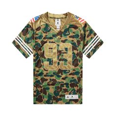 Find BAPE X Adidas Sb Jersey on Editorialist. BAPE reunites with adidas to create this SB Jersey for the SS19 season. Designed in green camouflage, the short-sleeve top nods to classic football jerseys with striped cuffs and a number on the front. Casual Camouflage T-shirt For Sports, Camouflage Short Sleeve Sports Top, Sporty Khaki Tops For Streetwear, Green T-shirt With Three Stripes Branding For Sports, Casual Camouflage Sports T-shirt, Green Streetwear Tops With Three Stripes, Green Three Stripes Tops For Streetwear, Sporty Khaki Tops, Sporty Khaki Tops For Sports