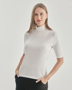 Grade 6A Mulberry Silk Breathable & Lightweight Lightweight & Comfortable Type: Silk T-ShirtMaterial: 92% Mulberry Silk + 8% Spandex Features: Satin, wear-resistant and stylish.Details: The snug fit of this turtleneck T-shirt accentuates your curves, highlighting your feminine silhouette in the most flattering way. The intricate knit pattern adds a touch of texture and depth, making this garment a standout piece in your collection. Indulge in the sumptuous softness of the knitted fabric against