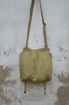 "DIMENSIONS: Bag: 32 x 32 x 12 cm / 12.5 x 12.5 x 5 inches Strap: ~ 125 cm / ~49\" CONDITION: Good vintage condition. This is an unused vintage military bag, it was deposited for long years so there may be a tiny scent that I find negligible and that will go away with time. If you want your bag to smell like new you can wash it when you receive it. Being made of fabric it is really easy to wash, I would recommend you to wash it by hand to preserve the colors better. Some of the metal parts may b Vintage Large Capacity Backpack Shoulder Bag, Vintage Shoulder Bag Backpack With Large Capacity, Vintage Khaki Shoulder Bag For Everyday, Everyday Vintage Khaki Shoulder Bag, Vintage Green Shoulder Bag With Large Capacity, Retro Khaki Travel Bag, Green Vintage Shoulder Bag With Large Capacity, Vintage Khaki Bags For Daily Use, Vintage Green Bag With Pockets