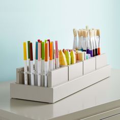 several different colored toothbrushes are lined up in a holder on a counter top