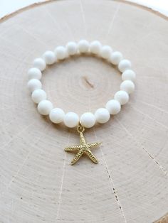 14k Gold Plated Starfish Charm 8mm White Shell Rounds Meaningful, Delicate, Durable, Giftable. MadebyMac Made with Love Recycled Bracelets, Pure White, Charm Bracelets, Pearl Beads, Starfish, Favorite Jewelry, With Love, Jewelry Bracelets, Shells