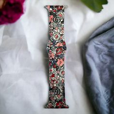 Welcome additional luxury to your Apple Watch with this exquisite GG Floral Silicone Watch Band. Soft and comfortable, its sophisticated design will add a touch of class to any occasion. Embrace a timeless look that exudes confidence, class, and sophistication!. *Beautiful silicone band *Standard Length *Available in 2 sizes: 38/40/41 MM and 42/44/45/49 MM *This band will fit every series of Apple Watches Elegant Pink Bracelet Strap Apple Watch Band, Luxury Pink Watch Band As Gift, Luxury Adjustable Apple Watch Band For Gift, Elegant Bracelet Strap Watch Bands As Gift, Elegant Adjustable Apple Watch Band, Luxury Pink Adjustable Watch Bands, Luxury Adjustable Pink Watch Band, Elegant Adjustable Pink Watch Bands, Luxury Adjustable Rectangular Apple Watch Band