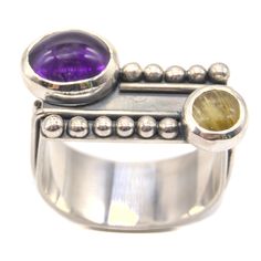 The Vibrant Visions Ring features deep amethyst and a golden yellow rutilated quartz, which creates beautiful contrast and a wonderful pop of color. This ring is a true miniature sculpture and holds detail and visual interest from every angle that you look at it. A one of a kind and unrepeatable design. Why U-rings?I love U rings because they allow for a larger statement ring without them spinning round and around your finger like round rings with a large stone or top tend to have. Sizing Size 9 Fusion Style Amethyst Gemstone Rings, Purple Gemstone Fusion Rings, Amethyst Gemstone Fusion Rings, Unique Multi-stone Citrine Rings, Unique Multi-stone Purple Amethyst Ring, Unique Multi-stone Amethyst Ring, Unique Purple Multi-stone Amethyst Ring, Unique Amethyst Multi-stone Rings, Multi-stone Amethyst Ring