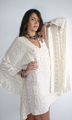 Lovely beige and cream designer tribal print silk Kaftan A perfect soft floaty addition to your summer wardrobe!  I manufactured this unique silk printed cover up for Nuove- Onde. Looks fantastic day or night with your favourite accessories or worn over jeans.  A versatile piece day or night.♥️ Please message me if you have any questions. White Printed V-neck Kaftan, Flowy Beige Kaftan For Summer, Beige Flowy Kaftan For Summer, Summer Beige Flowy Kaftan, Beige Bohemian Kaftan For Summer, Flowy Beige Kaftan For The Beach, Summer Bohemian Beige Kaftan, Bohemian Cream Tunic Kaftan, Bohemian White Silk Kaftan