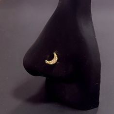 a black mannequin with a pair of earrings on it