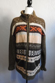 !00%  Wool handknit Ecuadorian  Sweater Cardigan by the Artisan group of Inti Ravmi.  The earth tones of Mossy Green, Browns,  Burnt Orange and Beiges show beautifully with the Incan inspired design. This will surely keep you warm on those chillier days. There is no tag for size, but looks like a Women's size large, or even a Men's size small. The collar can be zipped right up to the neck and there are 2 pockets in the front of sweater.  Length:29 inches Sleeves: 22 inches long Width: 48-inch ci Mossy Green, Unisex Sweater, Wool Cardigan, Earth Tones, Burnt Orange, Cardigans For Women, Warm And Cozy, Sweater Outfits, Hand Knitting