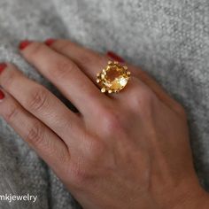 A lovely 10 carat oval citrine set in a wonderfully designed 18K yellow gold ring. The citrine is well cut has a great orangey color and is an immaculate looking stone.18K Yellow Gold Citrine 10tcw 16mm Band thickness 4.3mm Size 7.5 Resize available under request. Thank you for visiting our shop!Also, Follow us on Instagram https://www.instagram.com/dmkjewelryny/ Unique Oval Yellow Gold Topaz Ring, Luxury Yellow Gold Topaz Ring Gift, Elegant Oval Yellow Topaz Ring, Elegant Yellow Oval Topaz Ring, Elegant Amber Topaz Ring, Elegant Hallmarked Orange Topaz Ring, Luxury Round Topaz Ring For Gift, Elegant Orange Topaz Ring Hallmarked, Elegant Gold Citrine Rings