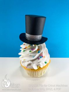 a cupcake with white frosting and a black top hat