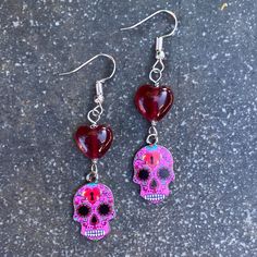 Crafted with exquisite expertise and using only the finest materials, these earrings feature stunning gemstones alongside a painted metal sugar skull, creating a truly distinctive and long-lasting accessory. Various skull designs and gemstone combinations to choose from. Perfect for Dia De Los Metros or Halloween! metal is stainless steel. Earring wires are hypoallergenic. We do our best to choose each stone carefully and purposeful for every piece.. However there might be slight differences in Bohemian Skull Earrings For Gifts, Pink Skull Jewelry For Halloween, Red Resin Drop Earrings, Skull Jewelry For Day Of The Dead Party, Skull Shaped Jewelry For Day Of The Dead Party, Nickel-free Skull Jewelry For Party, Nickel-free Skull Jewelry For Day Of The Dead, Nickel Free Skull Jewelry For Day Of The Dead, Nickel-free Red Halloween Jewelry