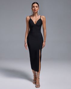 a woman wearing a black dress with a slit