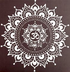 an intricately designed wall sticker in white on a brown background