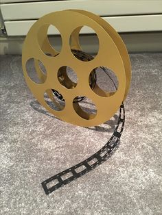 a film reel sitting on top of a carpeted floor