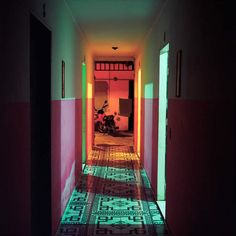 the hallway is lit up with neon lights