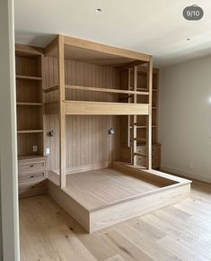 an empty room with bunk beds and shelves