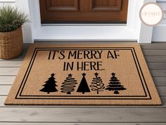 a door mat that says it's merry af in here with christmas trees on it