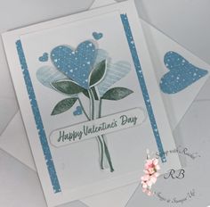 two valentine's day cards, one with a flower and the other with hearts