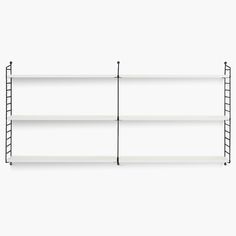 three white shelves with black metal bars on each shelf and one is empty, the other has