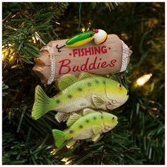 two fish ornament hanging from a christmas tree with fishing buddies written on it