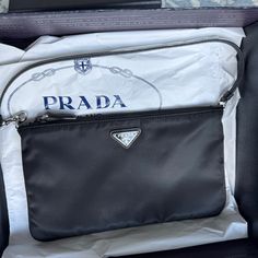 Prada Re-Nylon Mini Bag. Purchased In 2021 And Never Worn. Includes Box And Proof Of Authentication. Designer Black Bag With Silver-tone Logo Plaque, Designer Black Bag With Silver-tone Logo, Modern Travel Bags With Silver-tone Logo Plaque, Modern Travel Bag With Silver-tone Logo, Modern Travel Bag With Silver-tone Logo Plaque, Black Bag With Silver-tone Logo For Everyday Use, Elegant Nylon Bags With Silver-tone Hardware, Bags Prada, Prada Bags