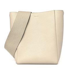 This is an authentic CELINE Soft Grained Calfskin Small Sangle Bucket Bag in Taupe. This ultra-chic shoulder bag is crafted of richly grained calfskin leather in beige. This shoulder bag features a canvas shoulder strap with aged gold clasps. The top opens to a matching suede interior with zipper and patch pockets. Celine Canvas Bucket Bag, Formal Cream Epsom Leather Bags, Cream Epsom Leather Bag For Everyday Use, Beige Epsom Leather Bag For Evening, Formal Beige Epsom Leather Shoulder Bag, Beige Epsom Leather Evening Bag, Elegant Cream Calf Leather Shoulder Bag, Beige Epsom Leather Bag With Detachable Strap, Luxury Cream Calf Leather Shoulder Bag